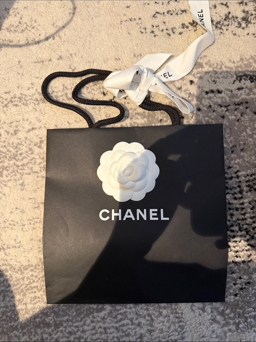 CHANEL Black Tote with White Camellia Emblem